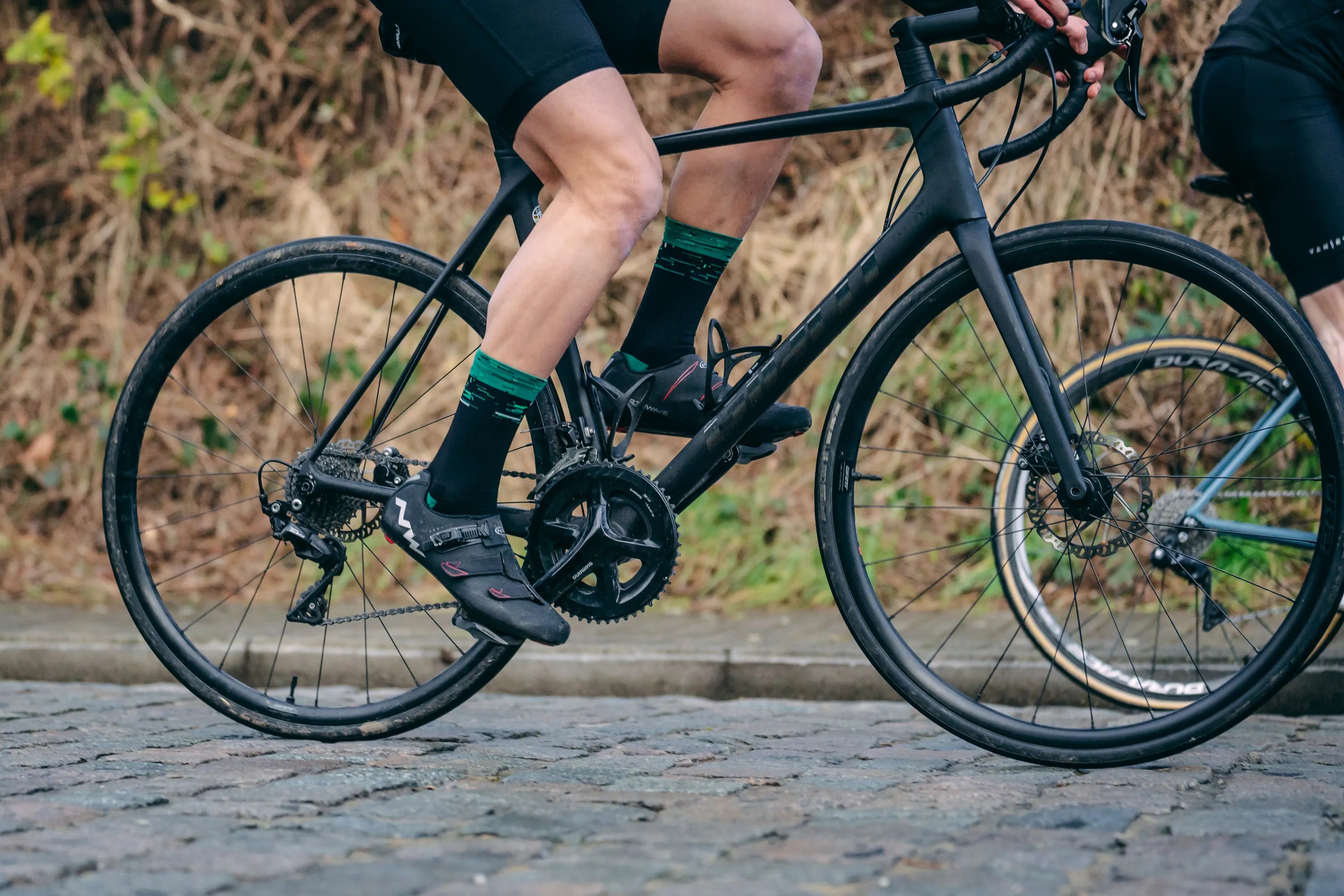 Performance cyclist wearing Watts in a Box premium cycling socks — Italian-made, Belgian design